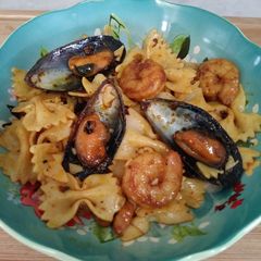 A picture of Bowtie pasta with seafood.