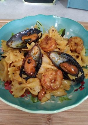 A picture of Bowtie pasta with seafood.