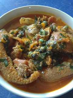 A picture of Spicy Ofe Achi with Assorted Goat Meat.