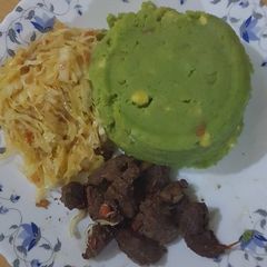 A picture of Mukimo served with cabbage and fried beef.