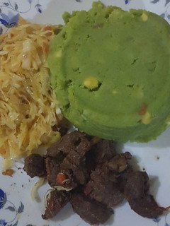 A picture of Mukimo served with cabbage and fried beef.