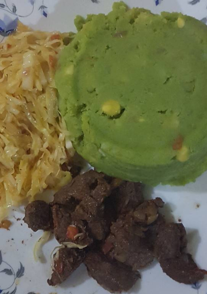 A picture of Mukimo served with cabbage and fried beef.