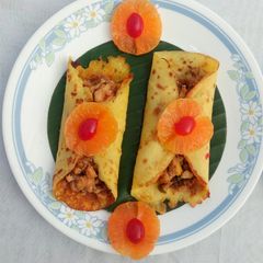 A picture of Orange pancake with chicken masala.