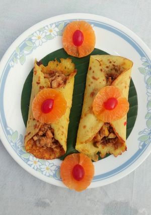 A picture of Orange pancake with chicken masala.