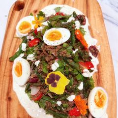 A picture of Kinda Nicoise with Fried Green Beans, Roasted Kale, Lentils, Boiled Eggs and Caper Mayo.