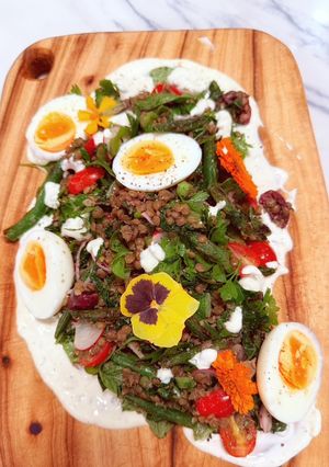 A picture of Kinda Nicoise with Fried Green Beans, Roasted Kale, Lentils, Boiled Eggs and Caper Mayo.