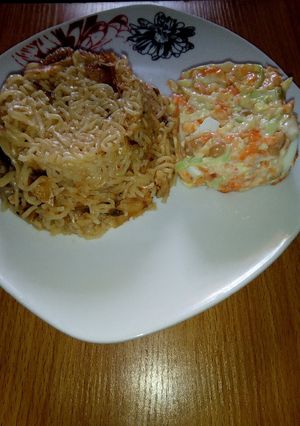 A picture of Noodles with dry fish and Coleslaw.