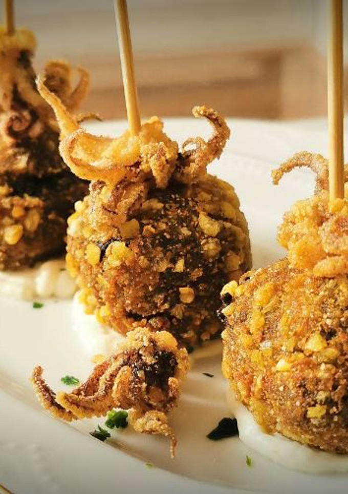 Una foto de Croquetas de chipirones en su tinta
