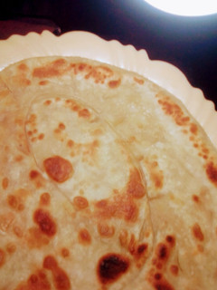 A picture of Chapatis, soft and layered.