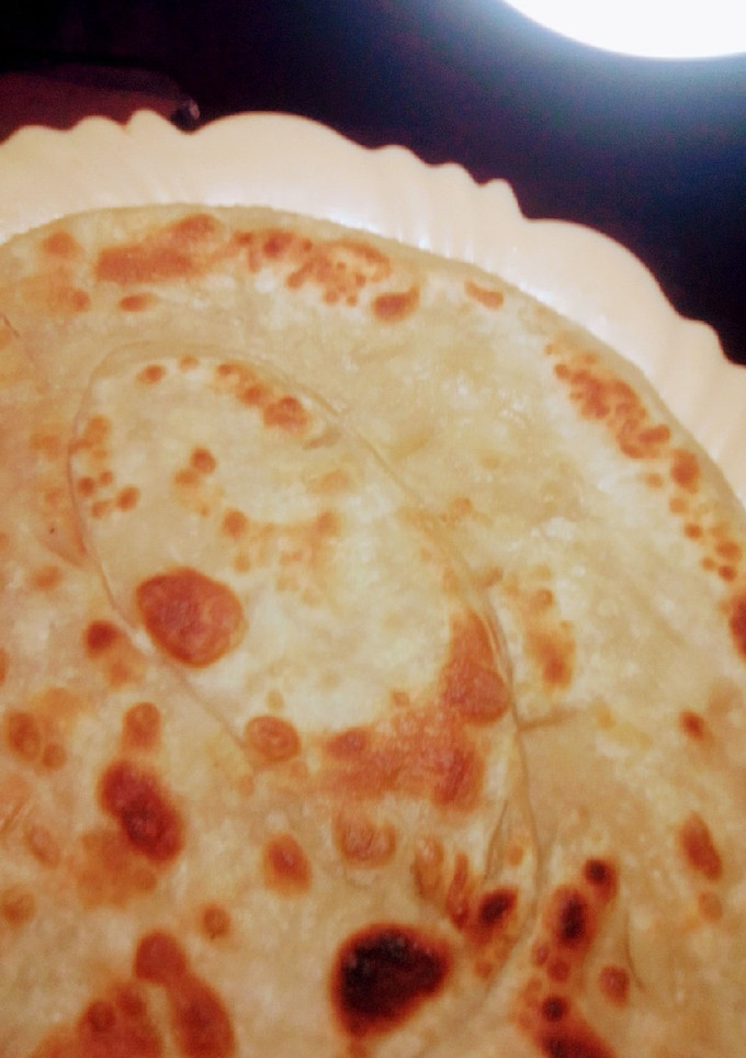 A picture of Chapatis, soft and layered.
