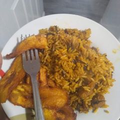 A picture of Jollof native rice with fried plantain.