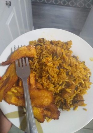 A picture of Jollof native rice with fried plantain.