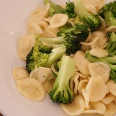 A picture of Home made pasta, orecchiette, with broccoli.