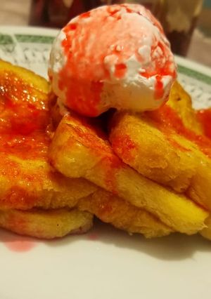 A picture of French toast with strawberry syrup and cream 🍽️.