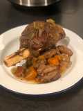 Slow cooked venison shank with chipolatas