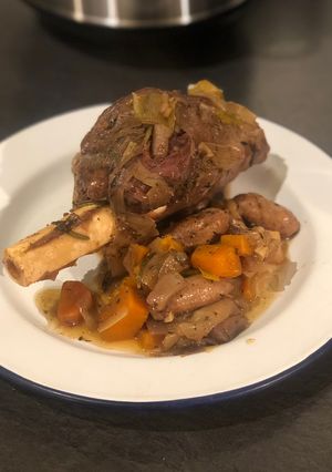 A picture of Slow cooked venison shank with chipolatas.
