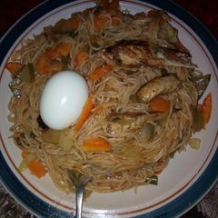 A picture of Spaghetti jollof & vegetables with fish & egg.