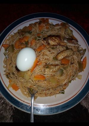A picture of Spaghetti jollof & vegetables with fish & egg.