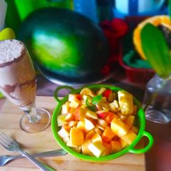 A picture of Fruit Salad with Cocoa milk.