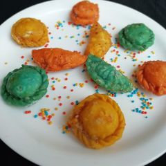 A picture of Colourful gujiya stuffed with kaju halwa.