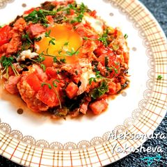 A picture of Fried Eggs with Bacon, Kale and Tomatoes.