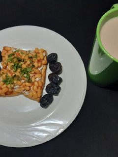 A picture of Beans on scrambled egg on toast.