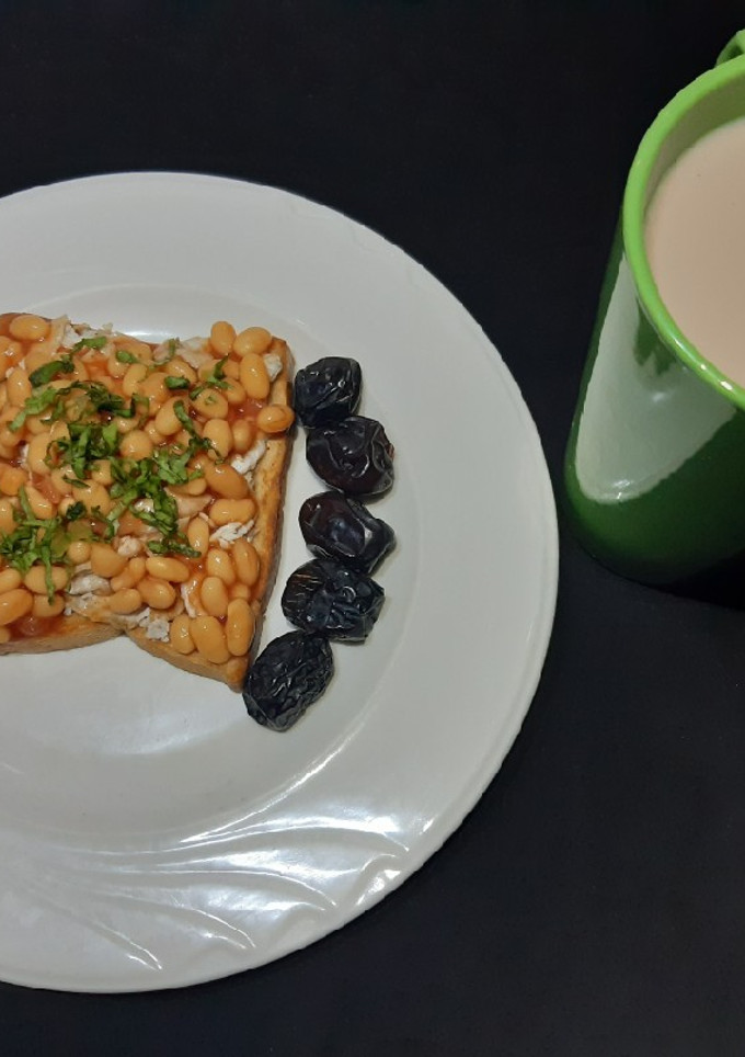 A picture of Beans on scrambled egg on toast.