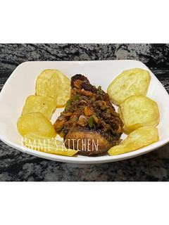 A picture of Fried fish coated in flour and sauce.