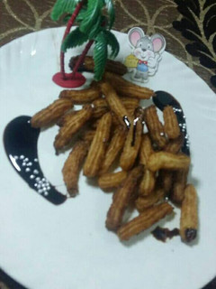 A picture of Eggless churros with chocolate sauce.