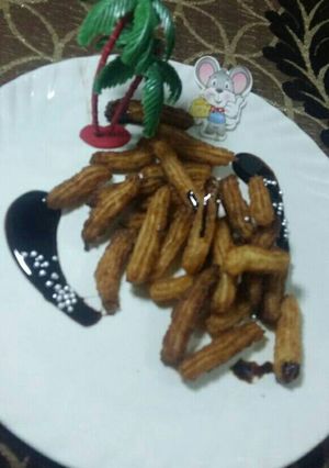 A picture of Eggless churros with chocolate sauce.