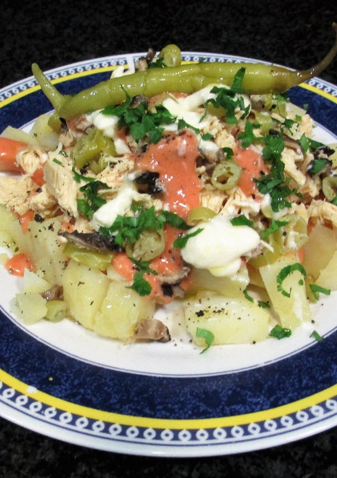 Una foto de Ensaladilla picante con patata y pechuga de pollo con lluvia de mayonesa rosa