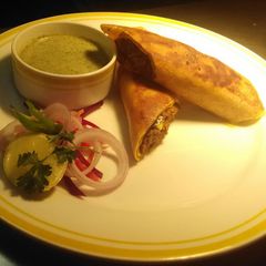 A picture of Dosa Katti Roll (Stuffed Dosa w Chicken Masala).