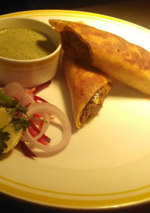 A picture of Dosa Katti Roll (Stuffed Dosa w Chicken Masala).