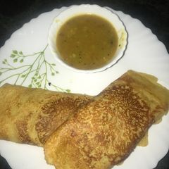 A picture of Moong Dosa with sambhar.