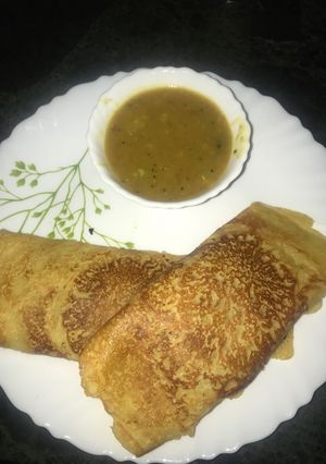 A picture of Moong Dosa with sambhar.