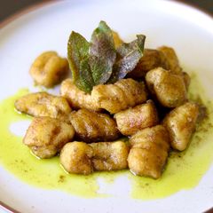 A picture of Potato and parsnip gnocchi with green pesto and crispy sage 🌿.