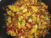 A picture of scrambled eggs with greens