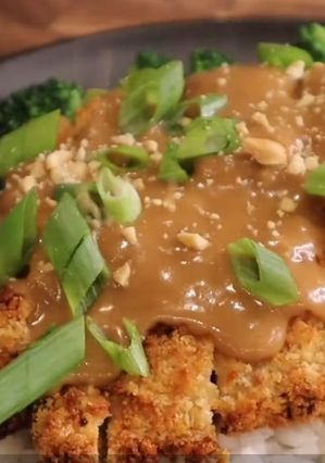 A picture of Chicken Katsu w/ peanut sauce.