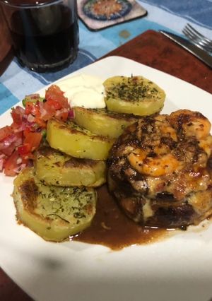 Una foto de Filete de res bardado, relleno con Camarones y papas Provenzal
