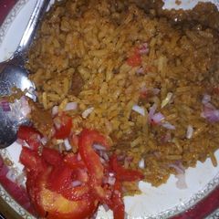 A picture of Beef pilau and kachumbari.