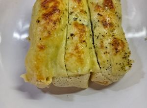 Una foto de Canelones de espinaca, pollo y ricotta