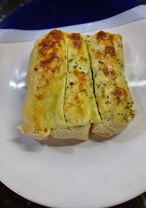 Una foto de Canelones de espinaca, pollo y ricotta