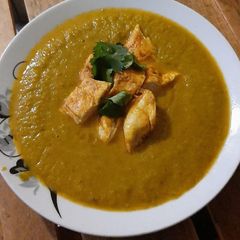 A picture of Indian spiced veg soup with grilled chicken fillet.
