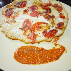 A picture of Bread Uttapam and Milagai Podi (south indian chutney).