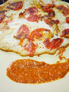 A picture of Bread Uttapam and Milagai Podi (south indian chutney).