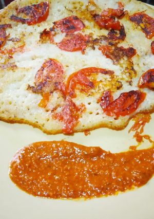 A picture of Bread Uttapam and Milagai Podi (south indian chutney).
