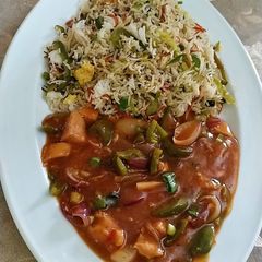 A picture of Fried rice with chicken shashlik.