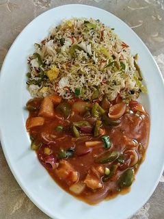 A picture of Fried rice with chicken shashlik.