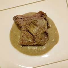 A picture of Slow roasted beef with bread and mushroom sauce.