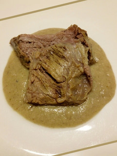 A picture of Slow roasted beef with bread and mushroom sauce.